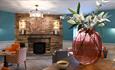 Image of a cosy seating area in front of a stone fireplace at The Park Head Hotel.
