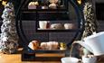 Cakes and sandwiches on a circular stand, festive afternoon tea at Seaham Hall