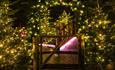 Image of the Plotters' forest softly lit with fairy lights.