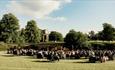 An audience watching outdoor theatre at Raby Castle