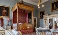 Bedroom at Raby Castle with a four poster bed, settee, table and chairs