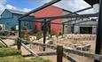 Credit: Scott Spock Photography
Image of Runa Farm's outdoor space, set up with a seating area amongst shrubs for an alfresco ceremony.