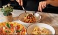 Pasta and pizza dishes at Veeno.
