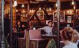 People enjoying drinks at The Hotspot Bar under soft lighting.