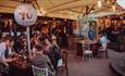 People enjoying drinks at The Hotspot Bar under soft lighting.