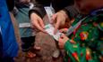 A group of adults and children looking at a leaflet - Credit Forestry England Crown Copyright