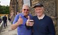 Two gentleman at Hopetown, smiling and  giving a 'thumbs up'.