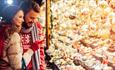 A couple browsing decorations at the Christmas Fayre