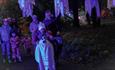 children dressed in halloween costumes on a spooky trail.
