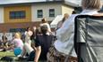 Crowds sitting on the lawn outside Bishop Auckland College.