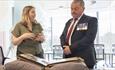 A man and woman looking at a photograph album from WWII