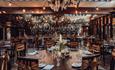 Beautiful tables, with floral centrepieces staged for a wedding celebration.