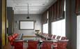 Meeting room with chairs, large table and screen