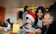 A child and their parents enjoying craft activities at The Bowes Museum Winter Market. ©TheBowesMuseum