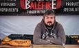 A man stood in front of a Balefire sign