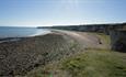 view of beach and cliffs