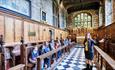 A group being shown Tunstall Chapel at Durham Castle