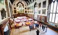 A group being shown around the Great Hall of Durham Castle