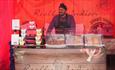 A food stall trader serving Indian food at Chester-le-eats food festival.