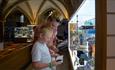 woman and child looking at books inside Durham Cathedral shop.