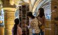 group of women looking at cards and postcards inside Durham Cathedral shop