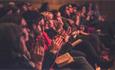 A group of people at a Durham Book Festival event who are seated and clapping.