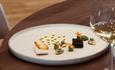 A beautifully presented meal paired with wine from the tasting menu at Faru - fine dining.