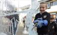 little boy chipping at ice sculpture at Fire and Ice Festival, Durham.