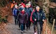 group of people walking towards High Force Waterfall