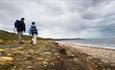 Two people walking on Horden beach