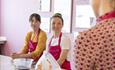 Two women watching chocolate making demonstration at La Chocolatrice Chocolate Making Workshop Studio