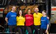 group of people in colours t shirts smiling at camera inside Locomotion museum.