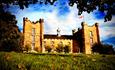 Lumley Castle exterior, blue skies, grass, trees