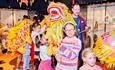 children and adults standing with a traditional lion puppet part of the Lunar New Year celebrations at Durham Oriental Museum.