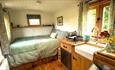 Double bed and Kitchenette at Sycamore Shepherd's Hut