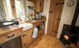 Kitchenette and log burner at Sycamore Shepherd's Hut