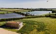 Overhead view of holiday lodge with surrounding countryside and Hurworth Burn Reservoir.