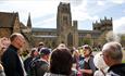 group of people stood outside Durham Cathedral on a guided tour