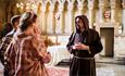 two people talking to person dressed as monk at Durham Cathedral