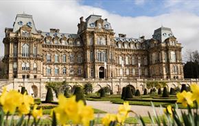 The exterior of The Bowes Museum and its grounds on a sunny day.