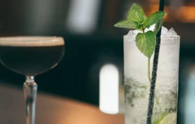 Espresso martini and lime cocktail with mint garnish