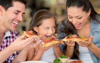 Parents and their child eating a meal