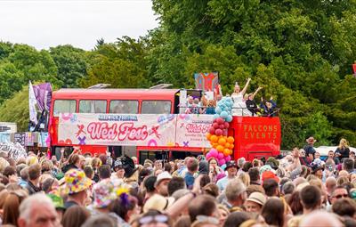 Bride and Groom at Hardwick Festival, riding on an open top bus