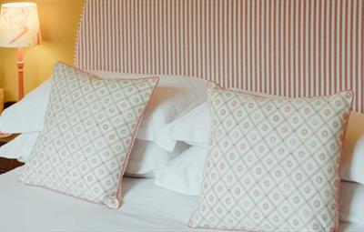 Comfortable bedroom with bedside lamp.