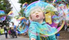 A child playing with bubbles at Hopetown Darlington.