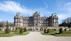 The exterior of The Bowes Museum and its grounds on a sunny day.