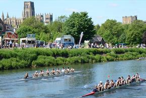 Teams of eight racing at Durham Regatta on a beautiful sunny day against the backdrop of Durham Cathedral and Castle.