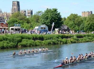 Teams of eight racing at Durham Regatta on a beautiful sunny day against the backdrop of Durham Cathedral and Castle.