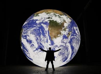 Large model of the earth with man standing in front.  Image credit: Natural Environment Research Council (NERC)

