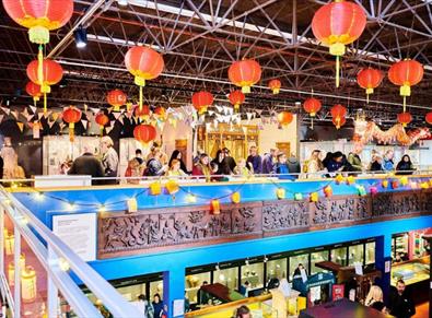 people standing under colourful lanterns as part of the Lunar New Year celebrations at Durham oriental Museum.